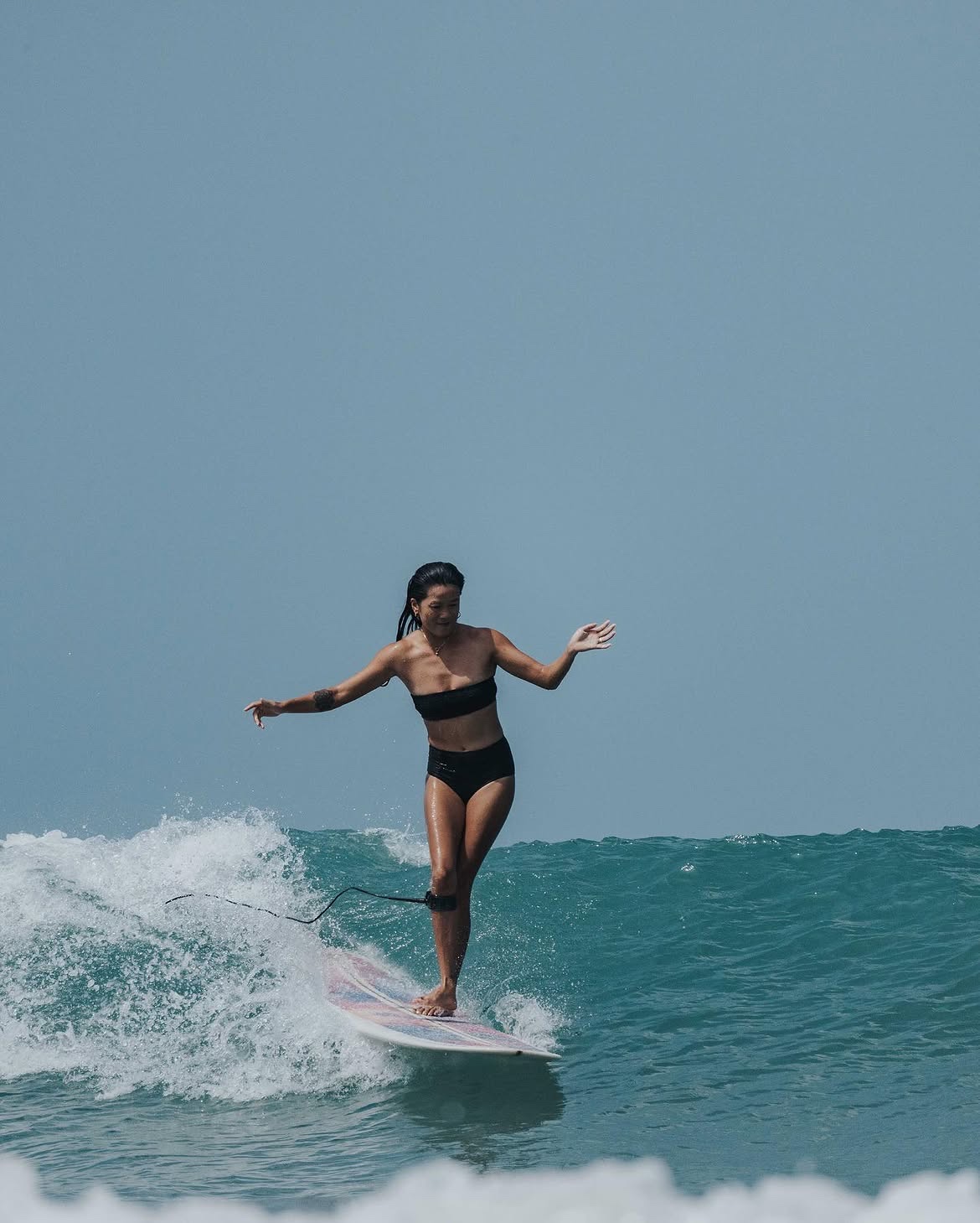 Monica (Qiezi) riding a longboard